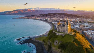 "Aerial panoramic view of Dunedin, New Zealand featuring Larnach Castle, Otago Peninsula coastline, city center's Victorian architecture, Dunedin Railway Station, Baldwin Street, and local wildlife at golden hour in 4K quality"