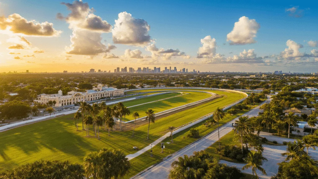 Hialeah in January: Your Ultimate Weather & Lifestyle Guide "Aerial view of Hialeah, Florida at sunset featuring Spanish-style architecture, palm trees, people in parks, and reflections on modern buildings, with a display showing a temperature of 75°F"