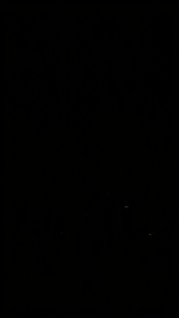 50 Stunning Black Wallpapers for a Chic Look A dark urban skyline with silhouettes of buildings and distant lights