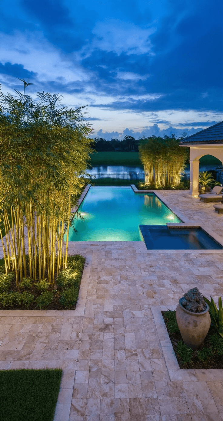 Dramatic twilight aerial view of a Florida pool landscape featuring intricate travertine paver patterns, illuminated by soft landscape lighting, with clumping Alphonse Karr bamboo, artificial turf borders, decorative containers with palms, and pool water reflecting a harmony of soft blues and greens.