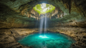 Unearth the Hidden Wonder: Devil's Den Spring - Nature's Most Insane Underground Swimming Paradise "Breathtaking underground cave swimming hole in Florida with turquoise water, stone stairs, ancient limestone formations, and mesmerizing natural lighting"